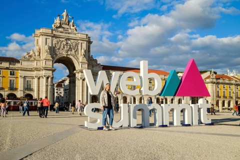 Nov 13, 2024 - Lisbon, Portugal: A female adult posing for a photo in front of Web Summit sign