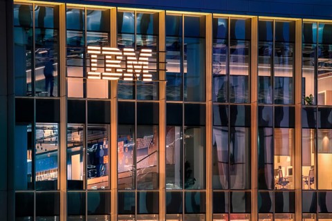 Jan 15, 2025 - Lisbon, Portugal: Nighttime view of IBM office building with glowing logo and sleek