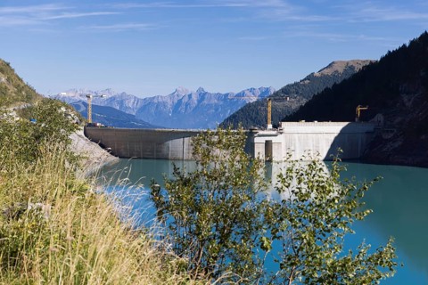 Waterfall bottom reservoir, dam wall, construction site, mountain panorama, energy industry, hiking