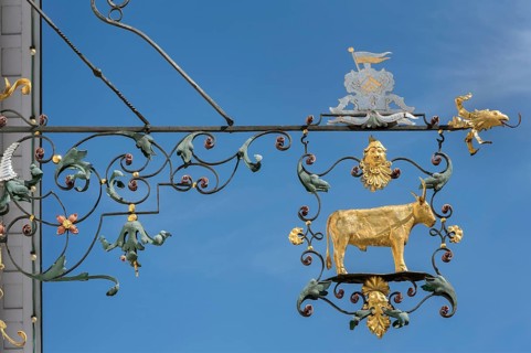 Wrought iron nose plate with golden bull in Kisslegg, Allgäu, Baden-Württemberg, Germany