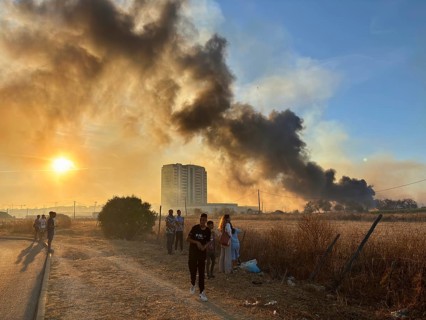 Faro, Algarve - September 21, 2025: People watching a big fire in the suburbs of Faro, capital city