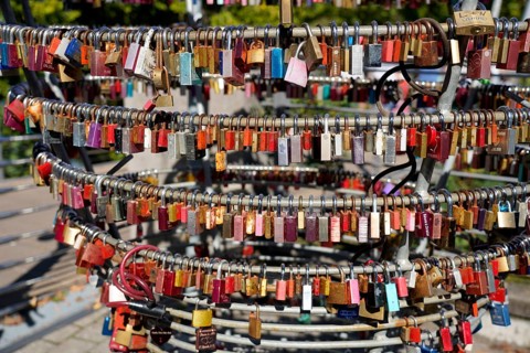 Close-up of numerous colourful padlocks attached to metal rings, Nuremberg, Middle Franconia,