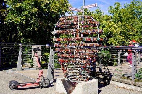 Electric scooter next to a large heart made of padlocks outdoors, Nuremberg, Middle Franconia,