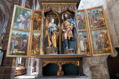 Historic altar with sculptures and religious paintings in a church, Church of St. Lawrence,