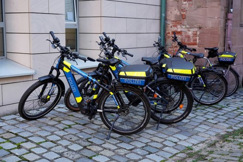 Police bikes with neon-coloured elements parked on cobblestones, Nuremberg, Middle Franconia,