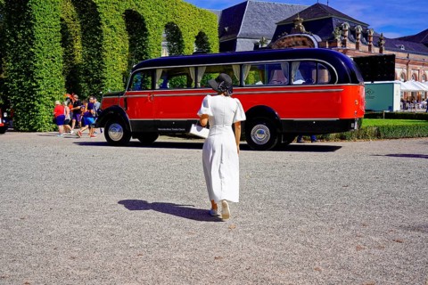 MERCEDES-BENZ 3500, built in 1950, retro bus in a park setting with a woman in the foreground,