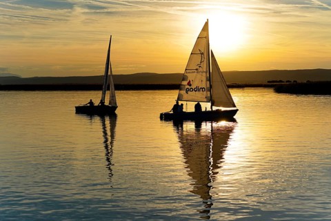 Lake Neusiedl, Burgenland, Austria, Europe, Two sailboats in the evening light with smooth water