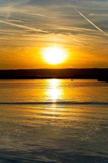 Lake Neusiedl, Burgenland, Austria, Europe, Sunset paints the sky in vivid colours while the water