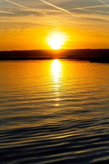 Lake Neusiedl, Burgenland, Austria, Europe, A magnificent sunset is reflected in the calm waters,