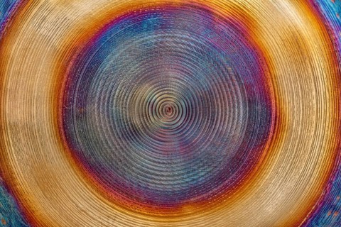 Full frame abstract closeup shot of a colorful metallic asian gong