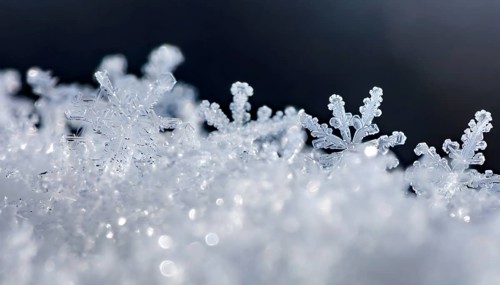 AI generated closeup image showing snow crystals in sunny ambiance