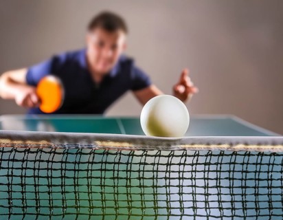 AI generated table tennis scenery including a ball, table with netting and player