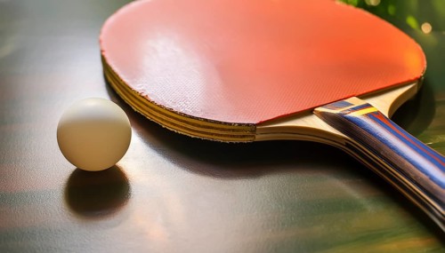 AI generated table tennis closeup scenery including a ball and rack on the table