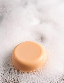 AI generated closeup image showing a soap bar and foam
