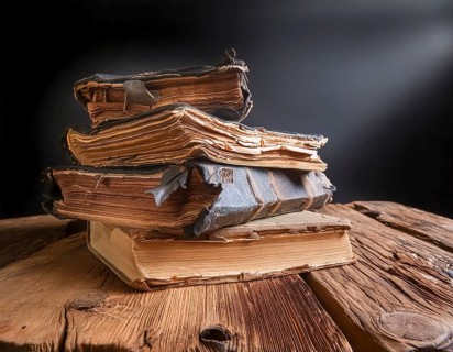 AI generated image showing stacked old rundown books on a wooden table