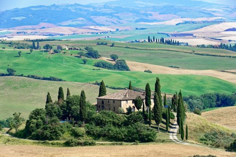 Large panoramic view of a Tuscan landscape with farmhouse and cypress trees, south of Pienza,