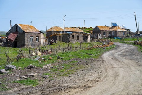 Quiet village with old buildings along a dirt road in a green landscape, Berdashen, Lake Arpi,