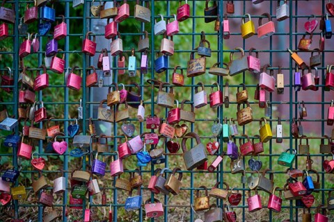Colourful love locks on an outdoor fence, Laboe, Kiel Fjord, Schleswig-Holstein, Germany