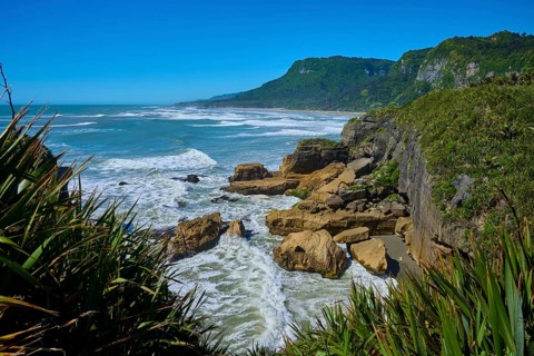 Rocky coast with stormy surf and dense vegetation, Pancake Rocks, Westport, Greymouth, West Coast,