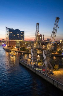 Aerial view of the Elbphilharmonie with Sandtorkai and historic cranes at the blue hour, Hamburg,