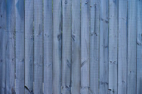 Close-up of a grey wooden fence with vertical panels and distinct texture, West Coast, South