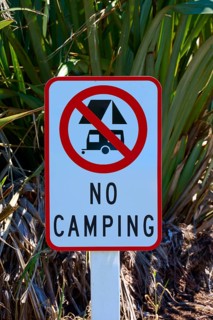 Sign prohibiting camping in a natural environment, West Coast, South Island, New Zealand