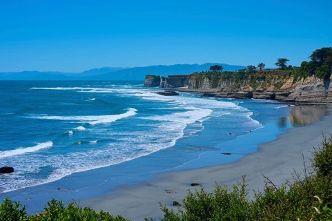 Wide view of the coast with waves, cliffs and blue sky, Cape Foulwind, West Coast, South Island,