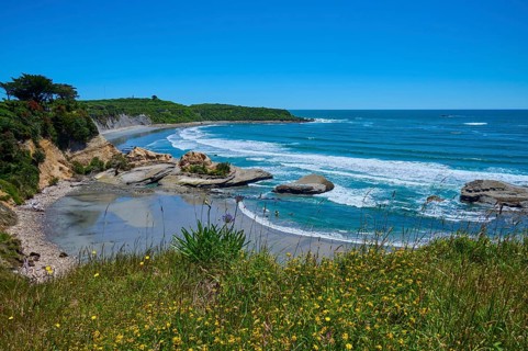 Coastal landscape with waves, rocks and blue sky, Cape Foulwind, West Coast, South Island, New