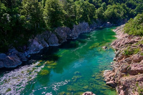 Emerald green river surrounded by rocks and dense forest, Buller River, Murchison, Tasman, South