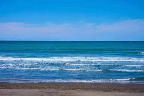 Calm beach with gentle waves on the blue horizon, Mana Bay, Patea, Taranaki, North Island, New