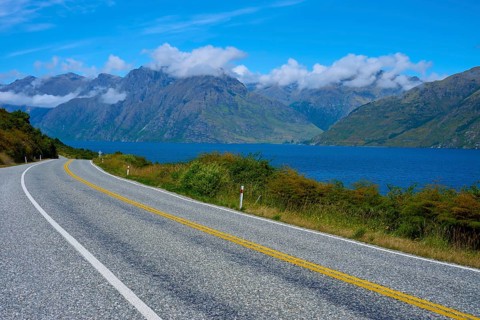 Winding road along a lake with mountains in the background, Devil's Staircase Lookout Point,