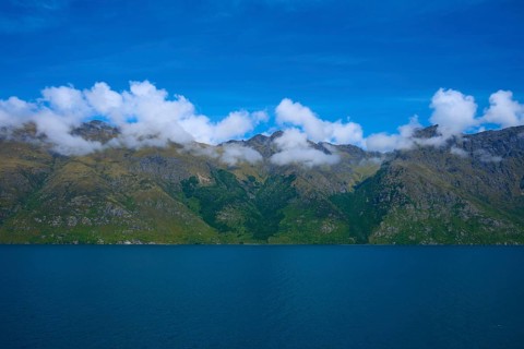 Tranquil landscape with mountains and a deep blue lake under a clear sky, Devil's Staircase Lookout