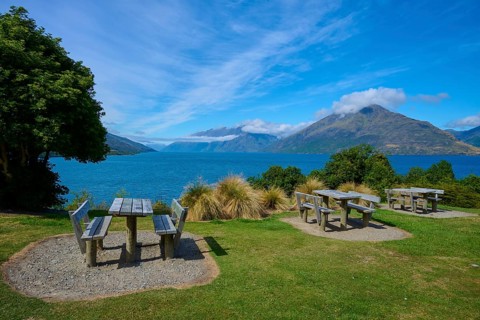Picnic tables with a view of a lake and mountains below, Drift Bay, Lake Wakatipu, Queenstown-Lakes
