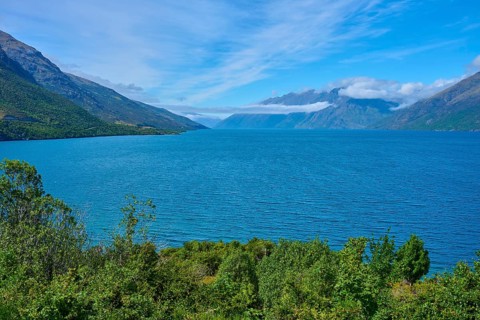 View of a lake framed by mountains and a blue sky, Drift Bay, Lake Wakatipu, Queenstown-Lakes