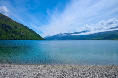 Peaceful beach landscape with blue sky and calm water, Kingston, Queenstown-Lakes District, Otago,