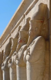Architectural detail of the Mortuary Temple of Hatshepsut in Egypt with stone sculptures in a row