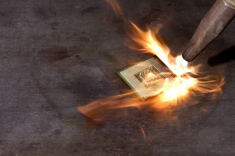 CPU and welding torch with big flame on metallic ground