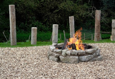 Outdoor fireplace with burning fire