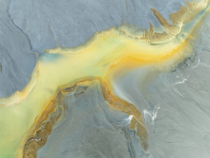 Abstract patterns in a waste pond in the mineral-rich area of the Rio Tinto mines. The colour is