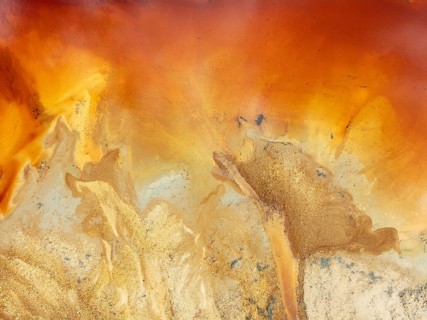 Abstract patterns in a pool in the mineral-rich area of the Rio Tinto mines. The colour is caused