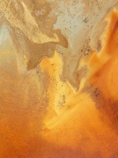 Abstract patterns in a pool in the mineral-rich area of the Rio Tinto mines. The colour is caused