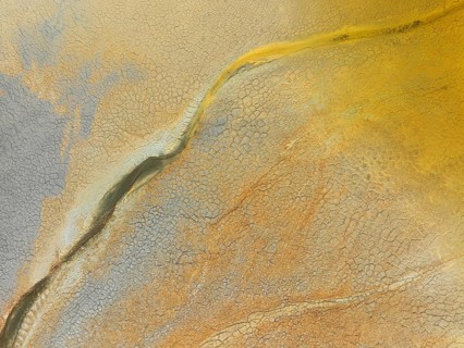 Abstract patterns in a waste pond in the mineral-rich area of the Rio Tinto mines. The colour is
