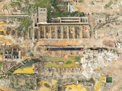 Old mining site and deep orange-red hues in the water of a pool in the mineral-rich area of the Rio