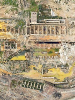 Old mining site and deep orange-red hues in the water of a pool in the mineral-rich area of the Rio