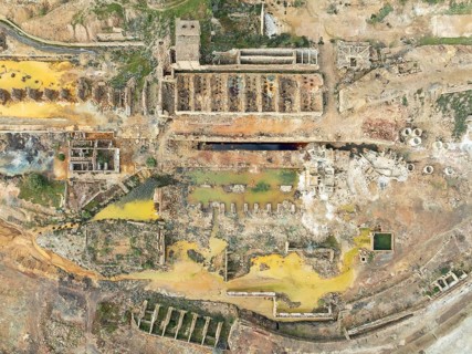 Old mining site and deep orange-red hues in the water of a pool in the mineral-rich area of the Rio
