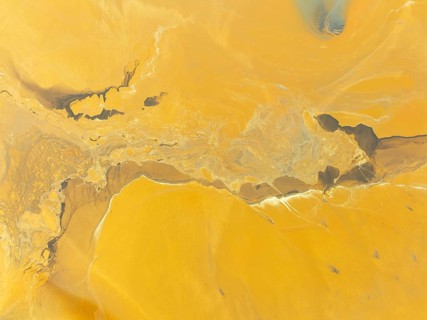 Abstract patterns in a waste pond in the mineral-rich area of the Rio Tinto mines. The colour is