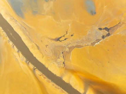 Abstract patterns in a waste pond in the mineral-rich area of the Rio Tinto mines. The colour is