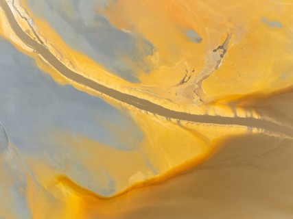 Abstract patterns in a waste pond in the mineral-rich area of the Rio Tinto mines. The colour is