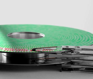 Detail shot of a hard disk platter with actuator arm and symbolic data error processing
