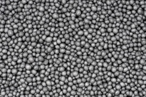 Full frame closeup showing lots of dark polystyrene beadlets